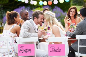 a group of people sitting around each other at a table.