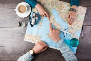 two people looking at a map on a table.