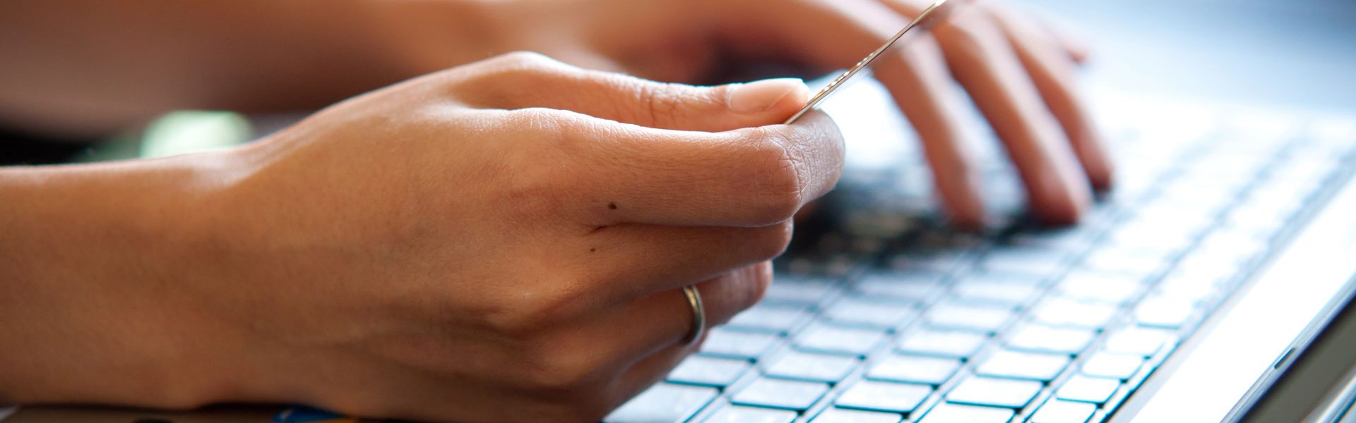 a person is typing on a laptop keyboard.